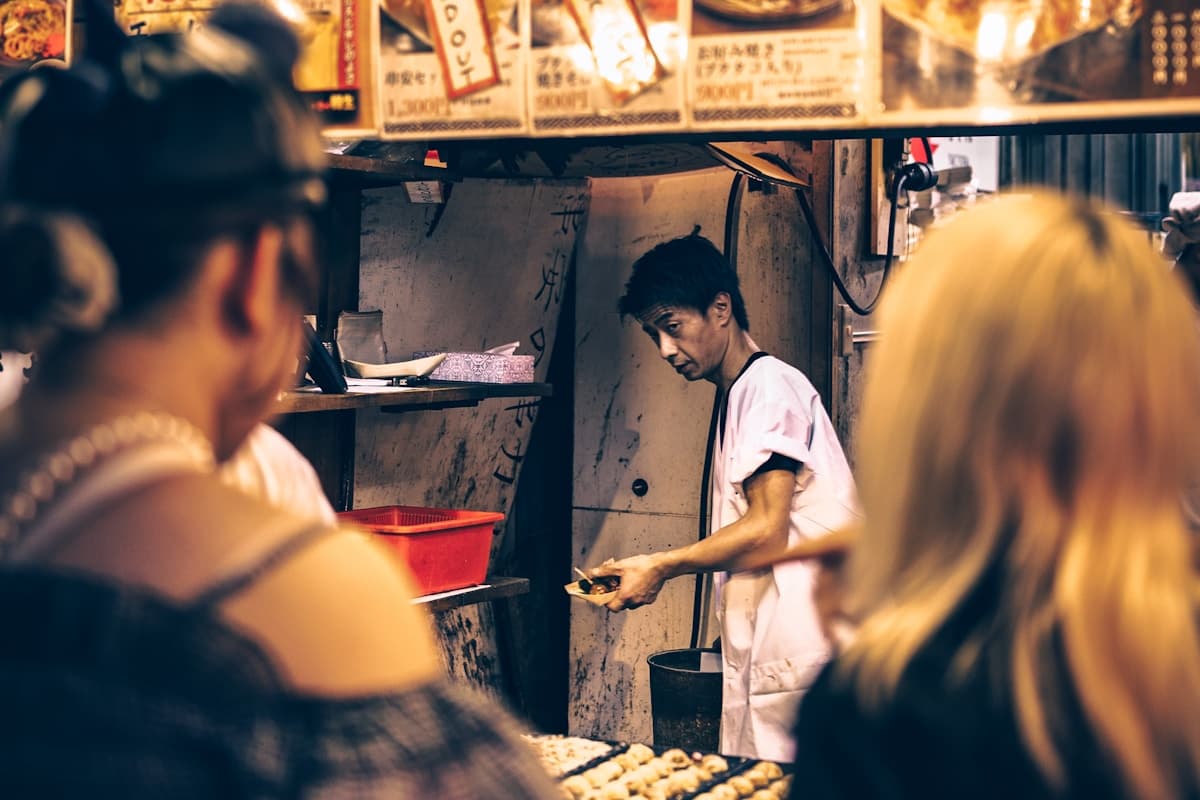 Vendor selling bright orange peppered shrimp at a roadside stall in Middle Quarters