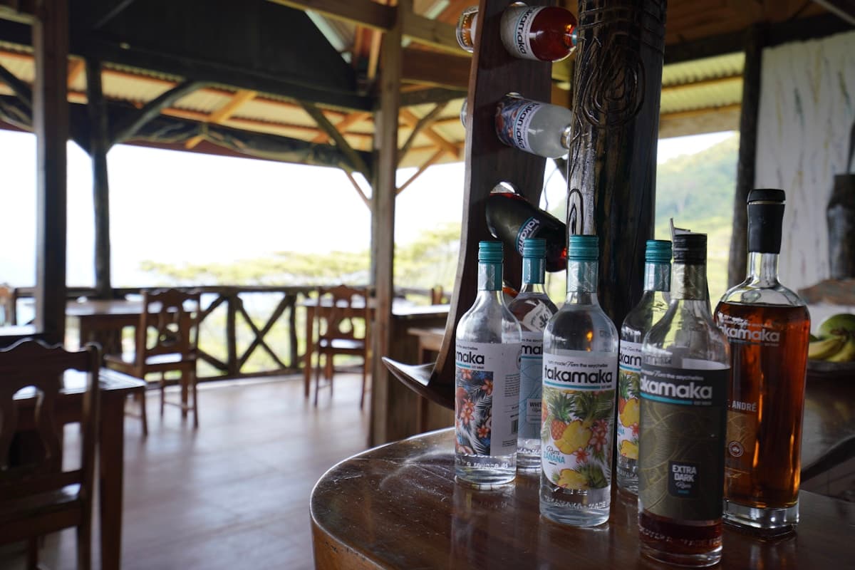 Locals playing dominoes at Rudy's Bar with cold Red Stripe beers